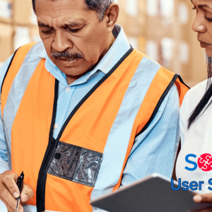 man and woman comparing notes in warehouse
