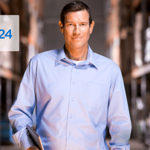 man in blue shirt smiling with a tablet