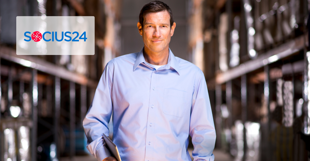 man in blue shirt smiling with a tablet