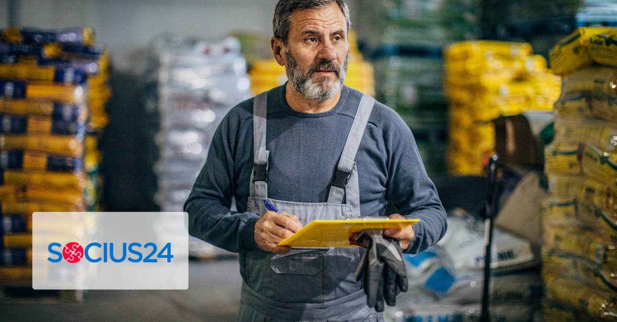Bearded man with clipboard walking through a warehouse