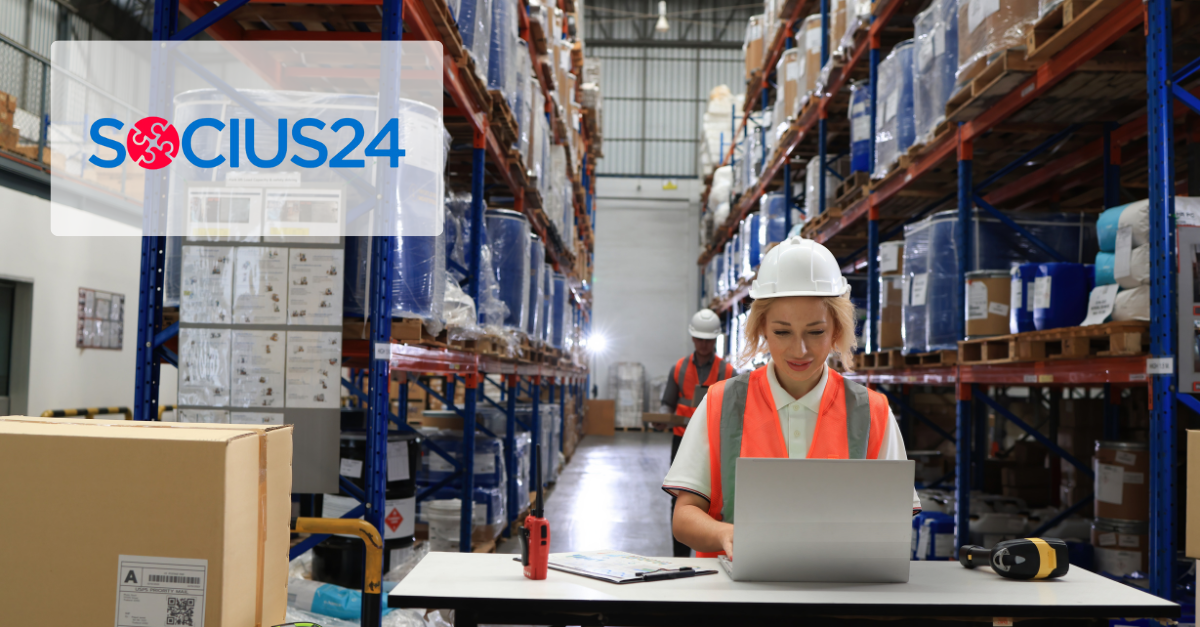 woman at table wearing safety gear while working on laptpo